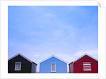 Beach huts in a row against sky by Assaf Frank